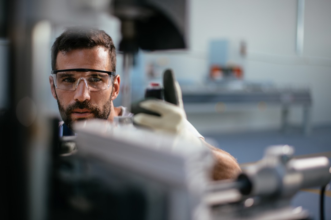 Manufacturing Worker Checking Piece