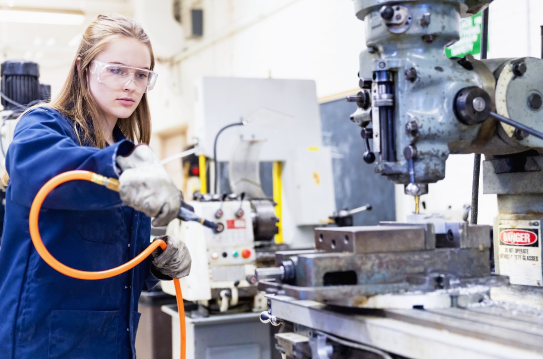 Female in Manufacturing Workplace with Air Hose