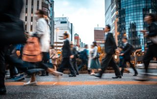 Busy city crosswalk with blurred people walking by