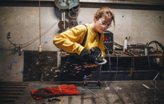 Young and confident metal working girl