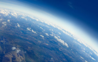 Aerial view of Planet Earth with clouds, horizon and little bit of space, make feelings of being in heaven. Cloudscape and stratosphere from above at 30000 feet.